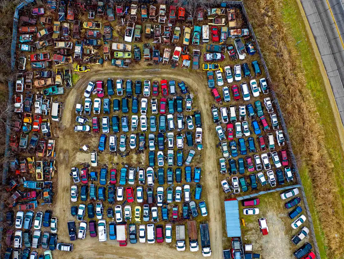 Aerial view of a large junk yard full of cars