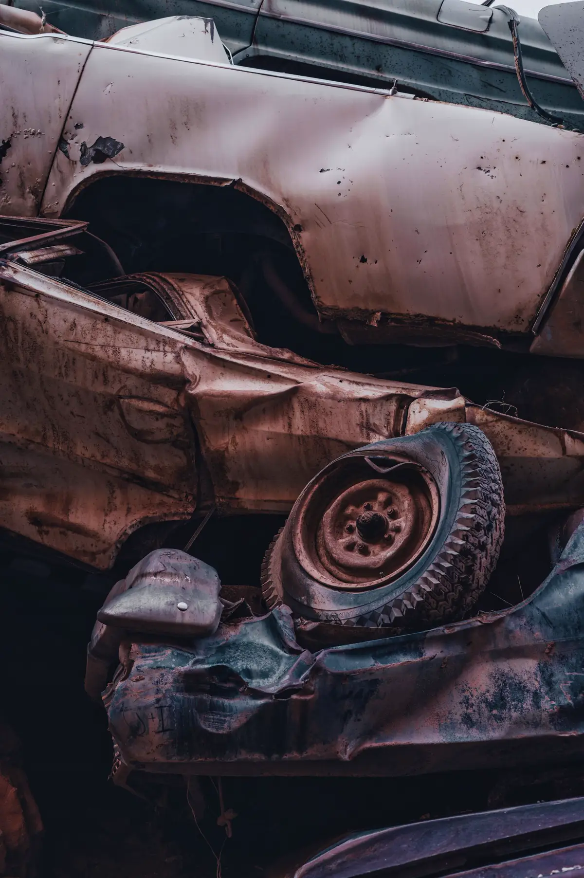 Close-up of crushed junk cars stacked for scrap