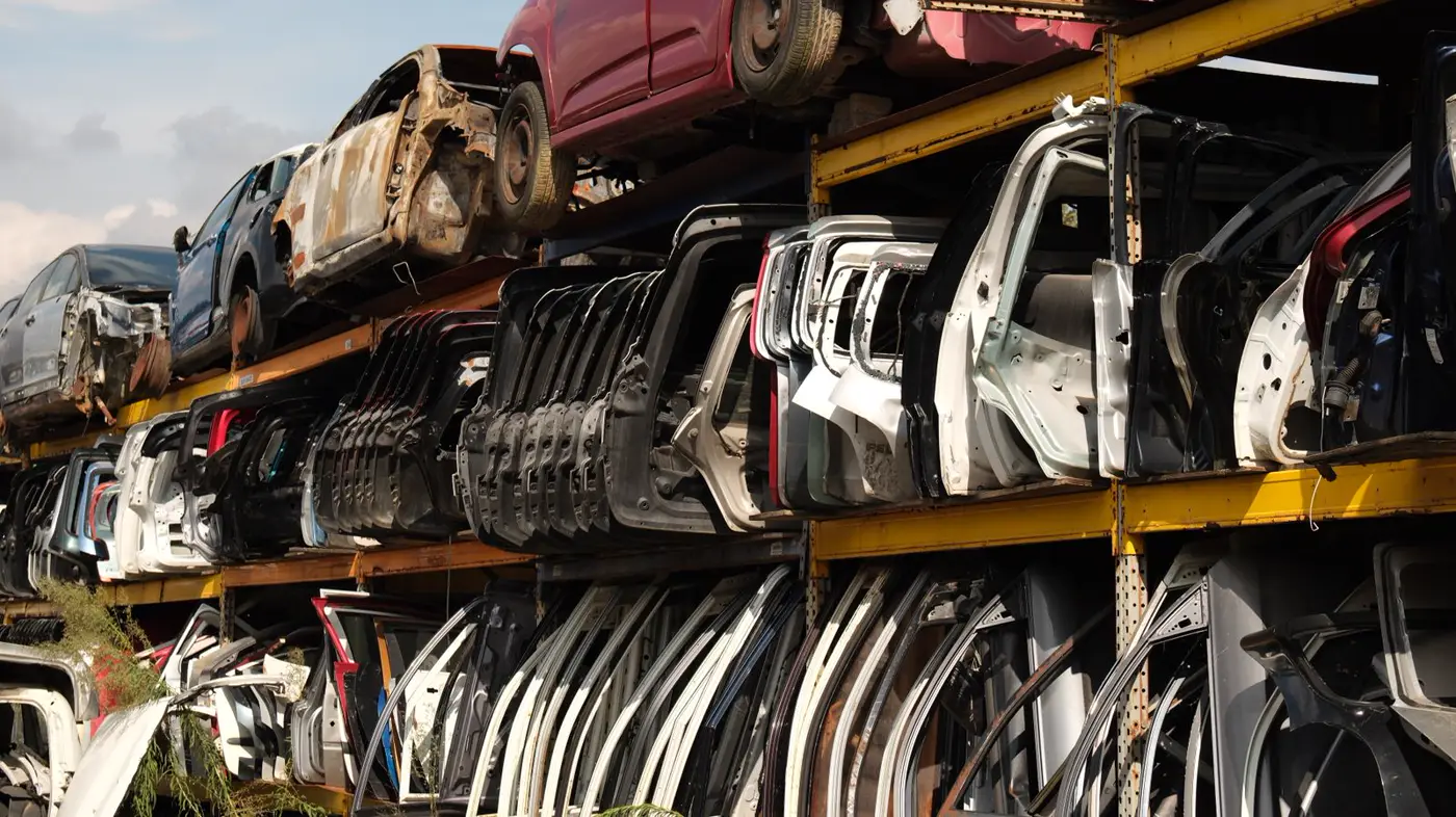 Rows of car doors and panels organized in a salvage yard
